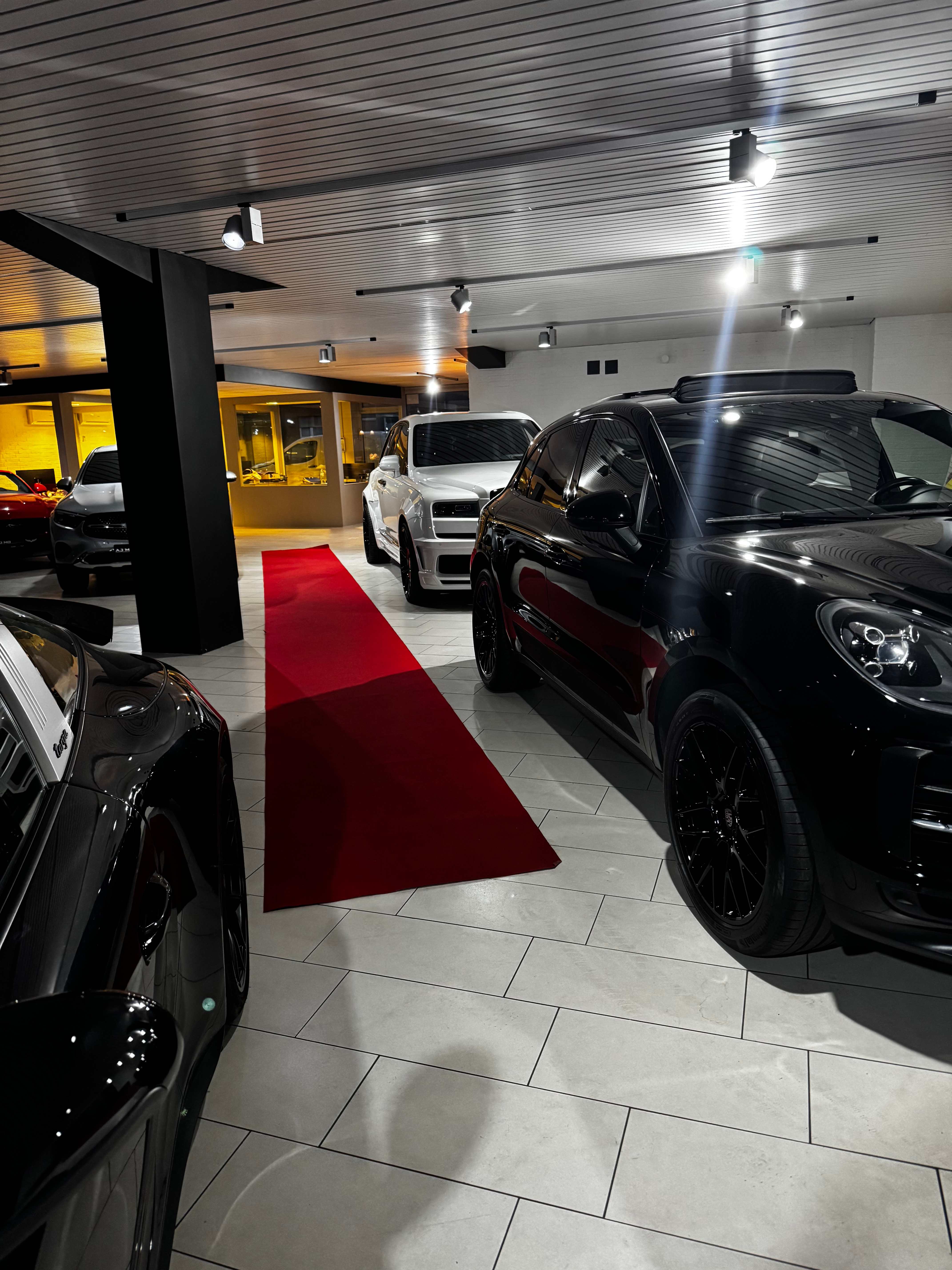 Erweiterter AJ Motors Showroom von innen mit rotem Teppich